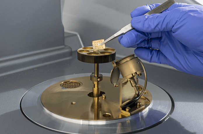 Zongliang Xie places the fabricated film capacitors into the ion sputtering machine for evaluation